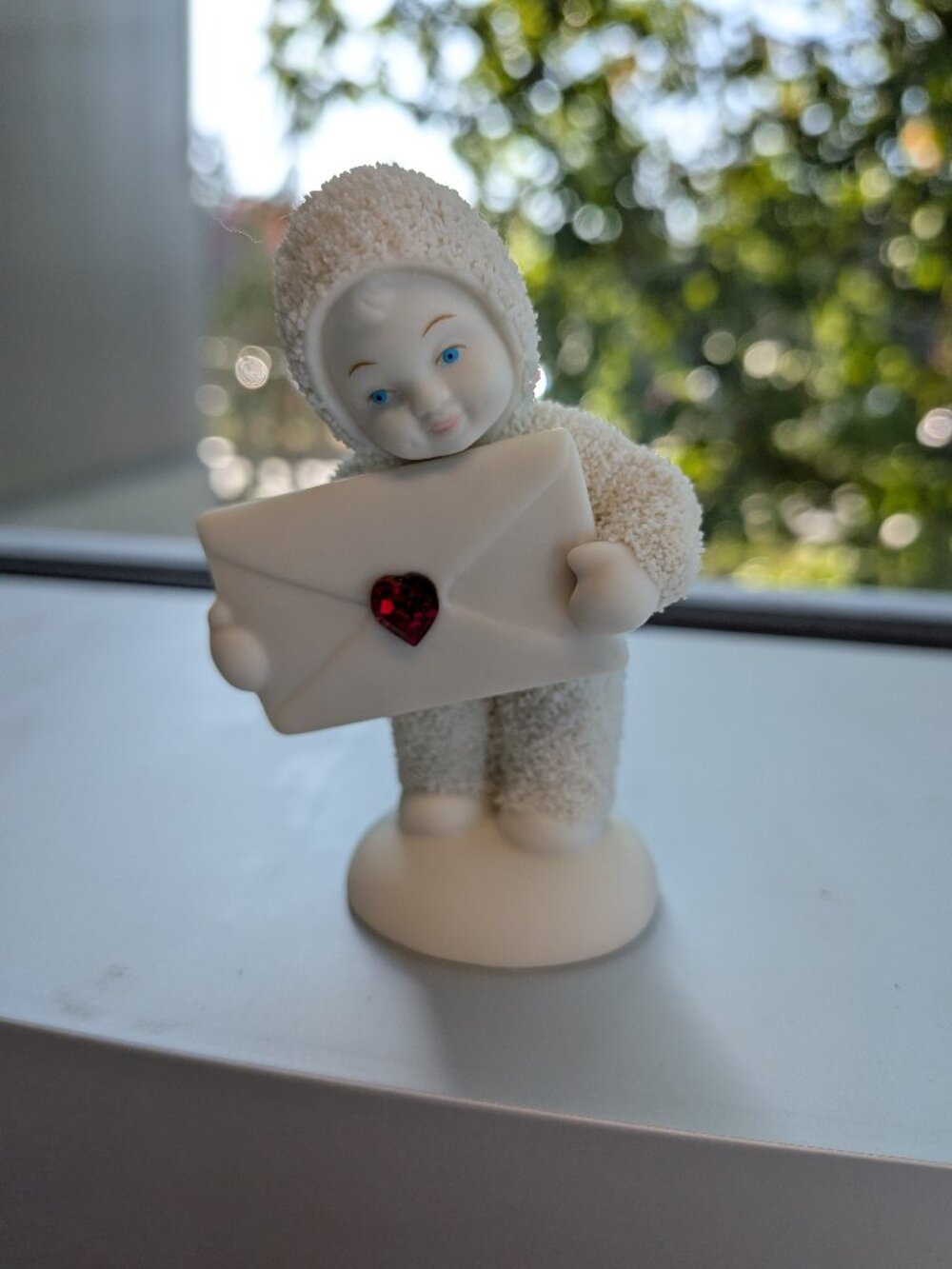 Department 56 Snowbabies Figurine - Baby Holding Envelope with Red Jewel